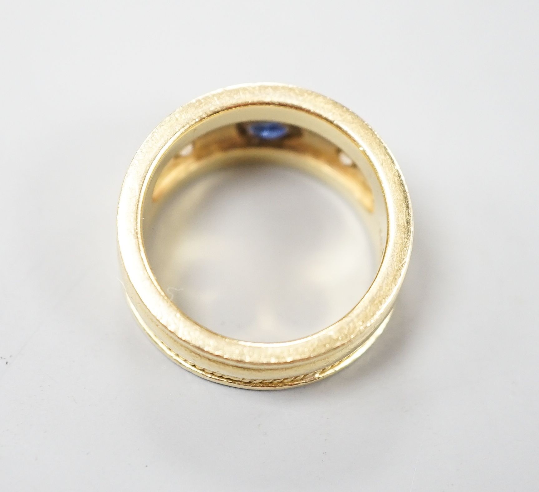 A modern yellow metal and collet set sapphire and diamond three stone ring, signed Charles Greig, size M, gross weight 11.5 grams.